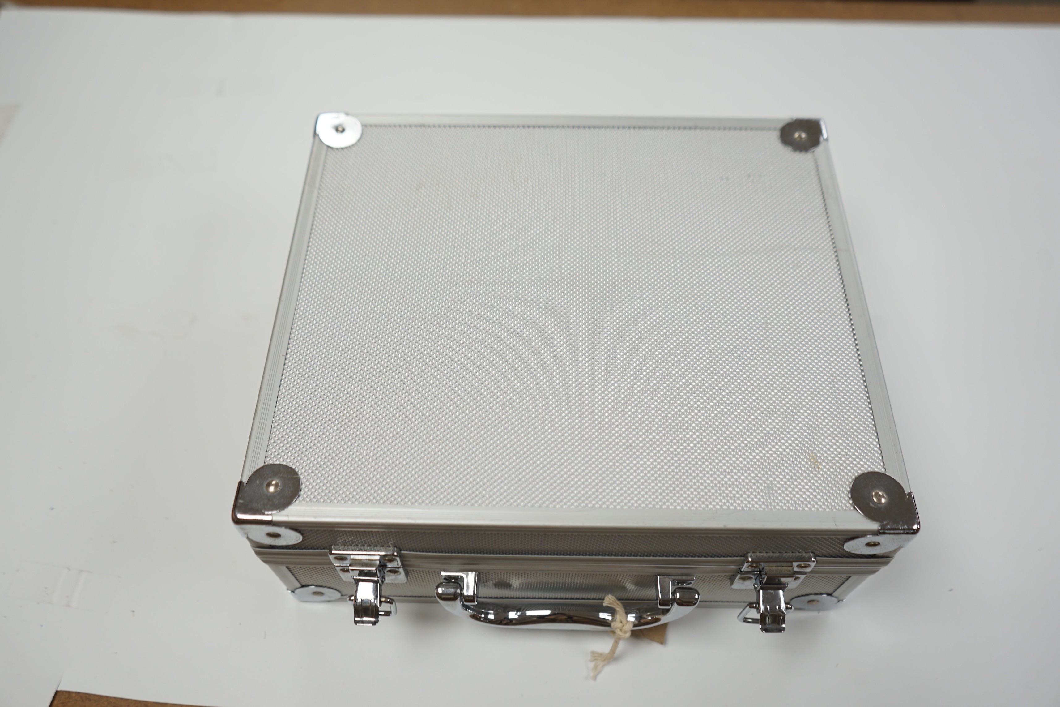 A metal case containing mixed collectibles including treen whistles, a cigarette case, three white metal propelling pencils etc